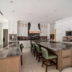 Custom white oak and painted kitchen with a natural-stone island | Sunshine Alliance, Boca Raton FL