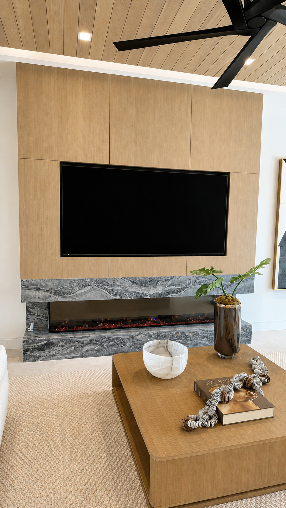Fireplace feature wall with millwork surround | Sunshine Alliance, South Florida