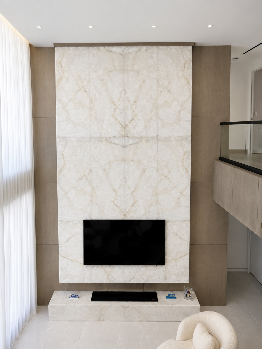 White marble fireplace and TV wall millwork | Built in-house by Sunshine Alliance