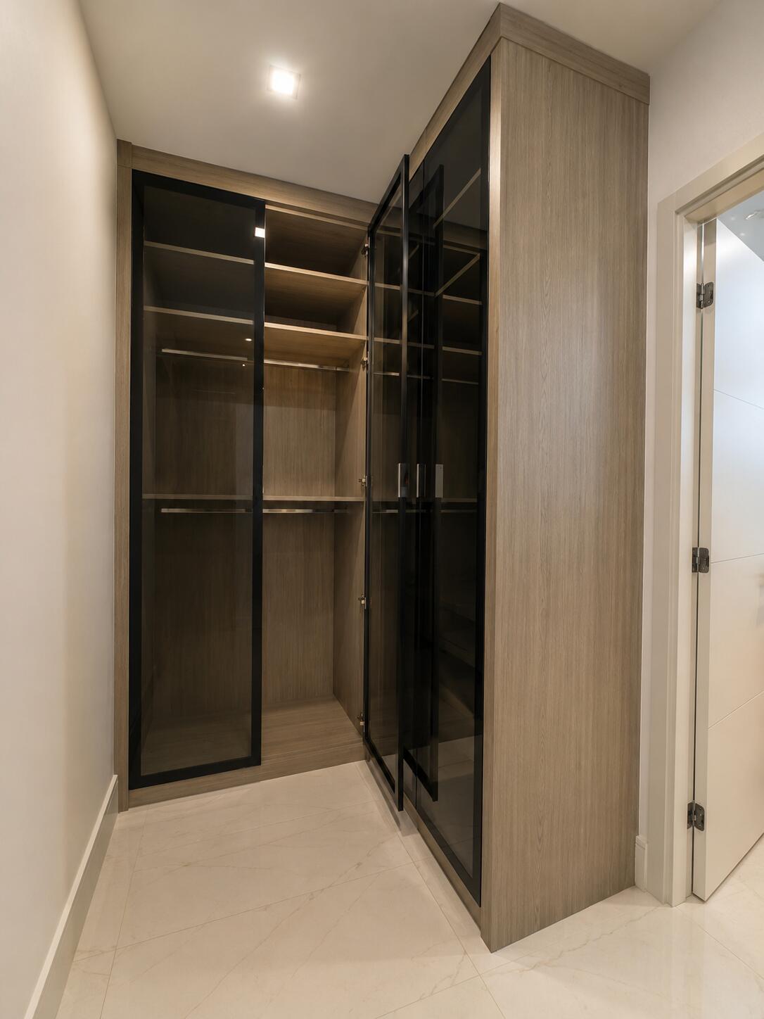 Custom closets South Florida — glass front walk-in closet | Sunshine Alliance, Boca Raton FL
