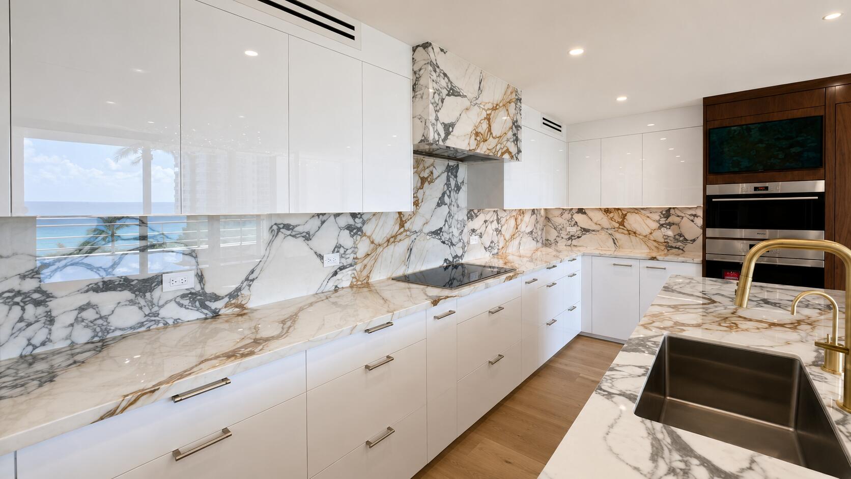 White gloss kitchen bookmatched marble | Sunshine Alliance, West Palm Beach