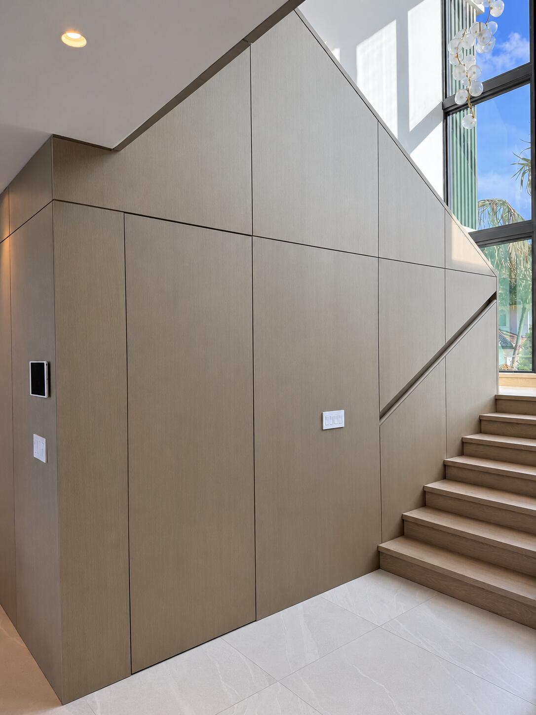 Wood paneled staircase wall architectural millwork by Sunshine Alliance, Boca Raton FL