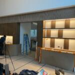 The Hamptons media wall under installation with fluted header and lit shelving | Sunshine Alliance, Hamptons NY