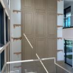 Custom paneled feature wall going up against ledger cleats in a luxury home | Sunshine Alliance, South Florida