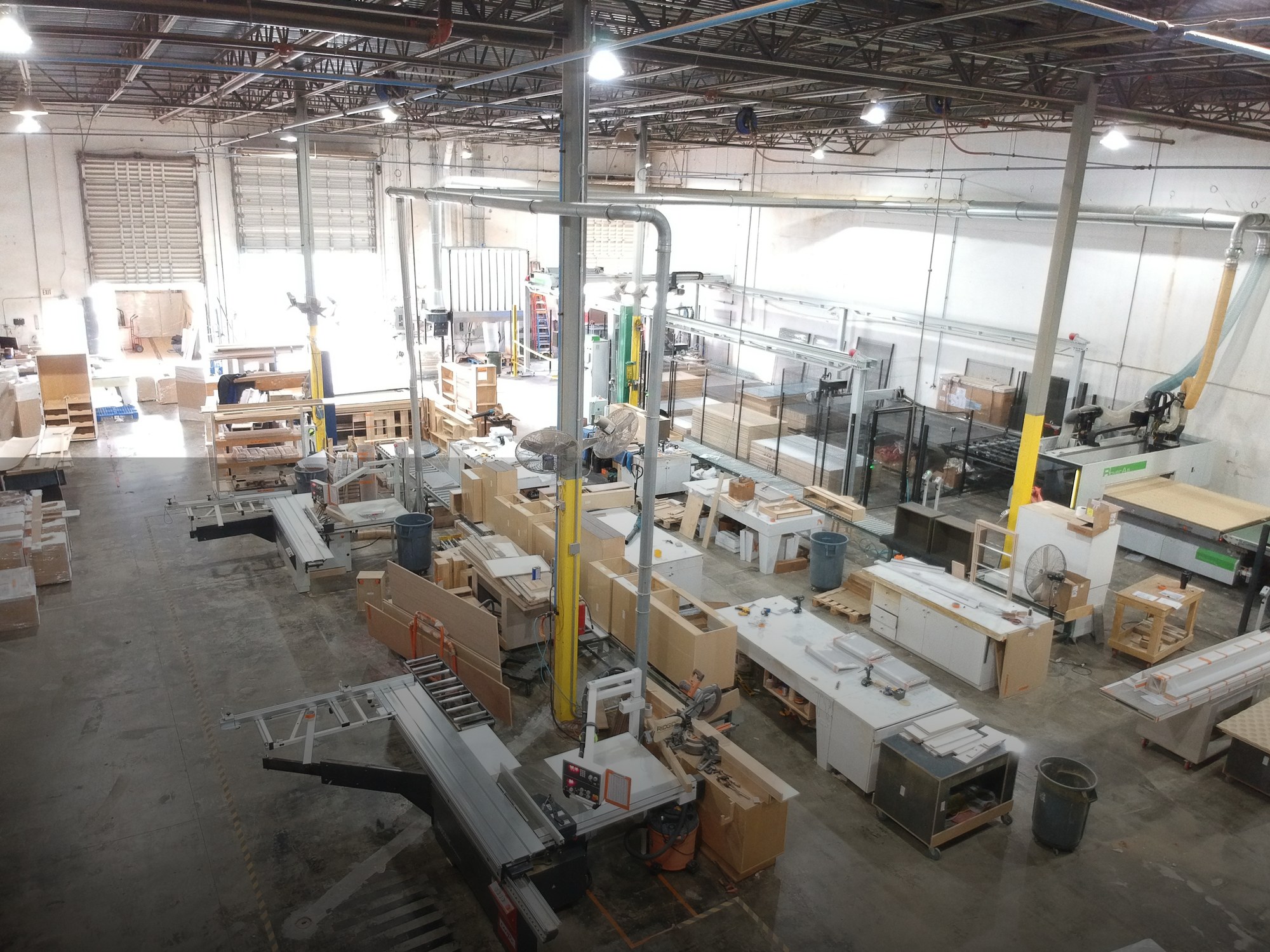 Working shop floor at Sunshine Alliance, Biesse Rover A router and Stream A Smart edge bander in operation, Deerfield Beach Florida.